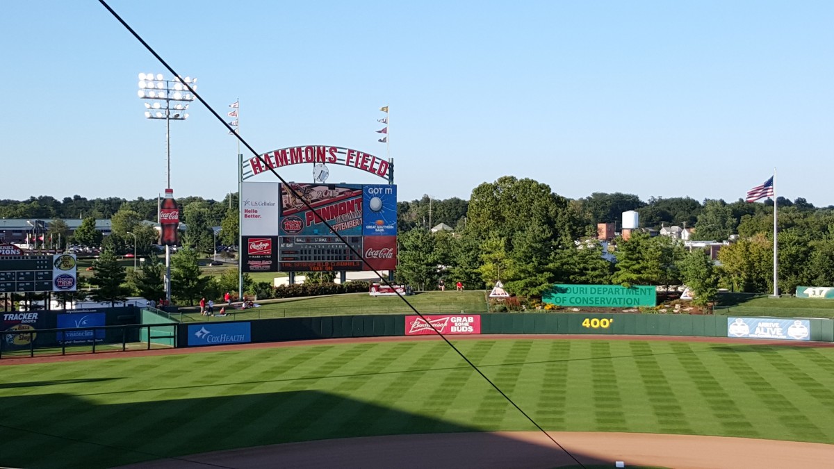 A baseball field and scoreboard at the ballpark.