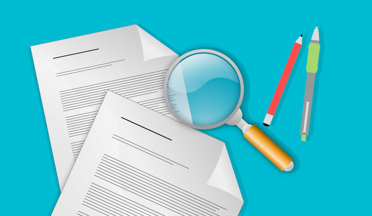 Illustration of documents and a magnifier used to review records.