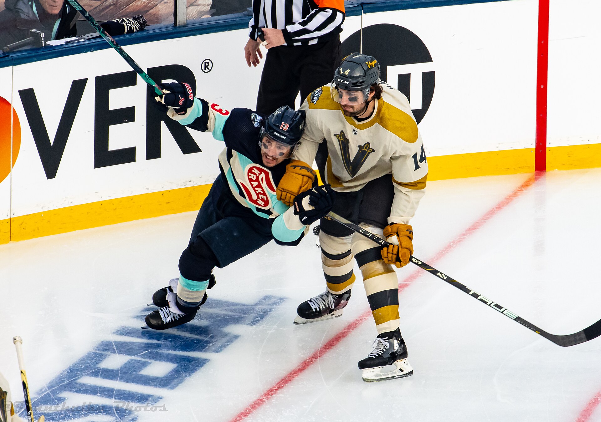 Seattle Kraken and Vegas Golden Knights players battling for the puck