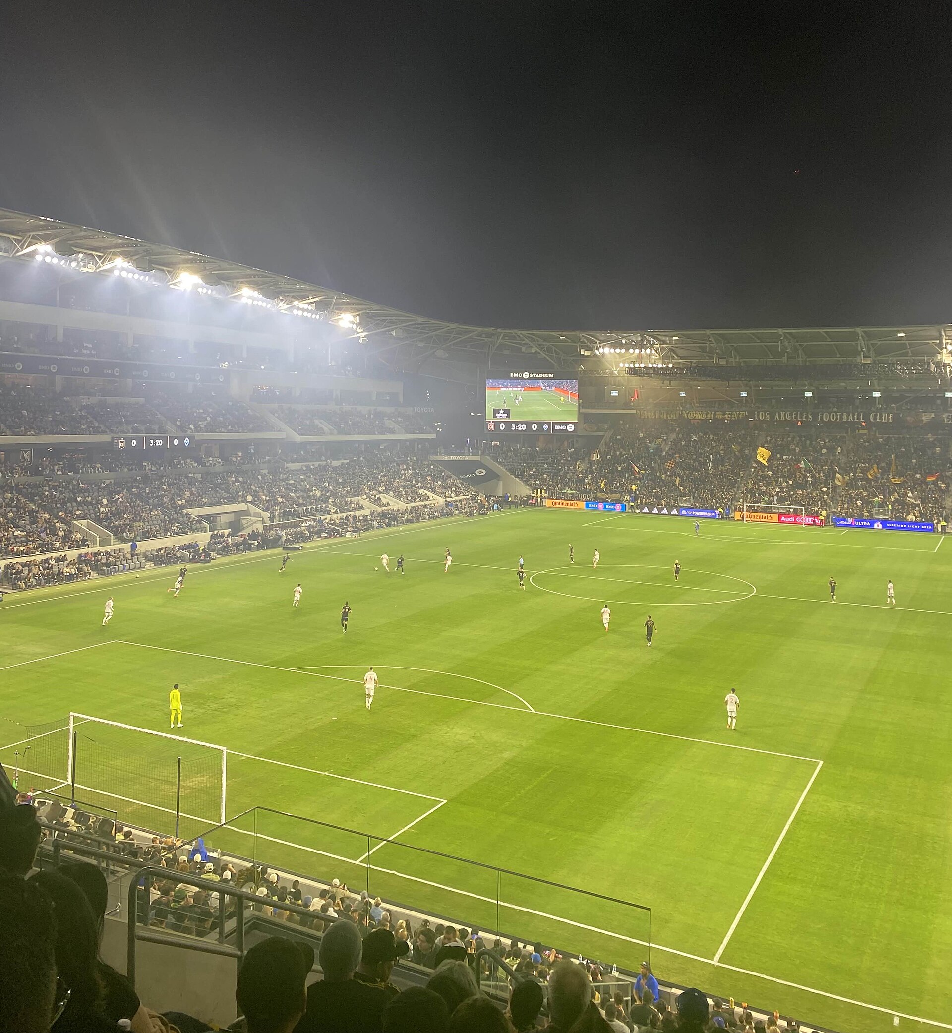 Los Angeles FC and Vancouver Whitecaps playing soccer at night