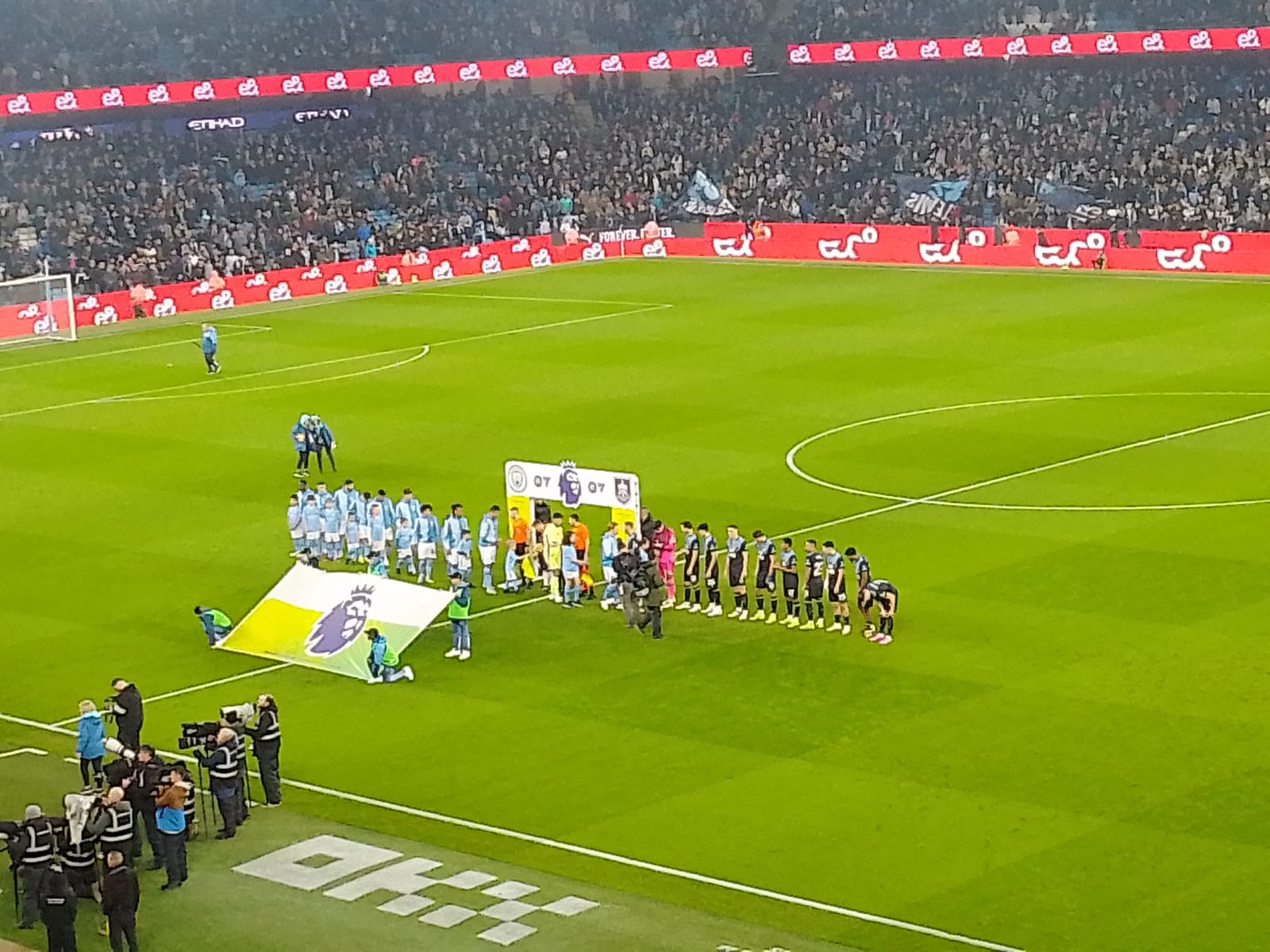 Manchester City and Burnley teams lining up on the football pitch